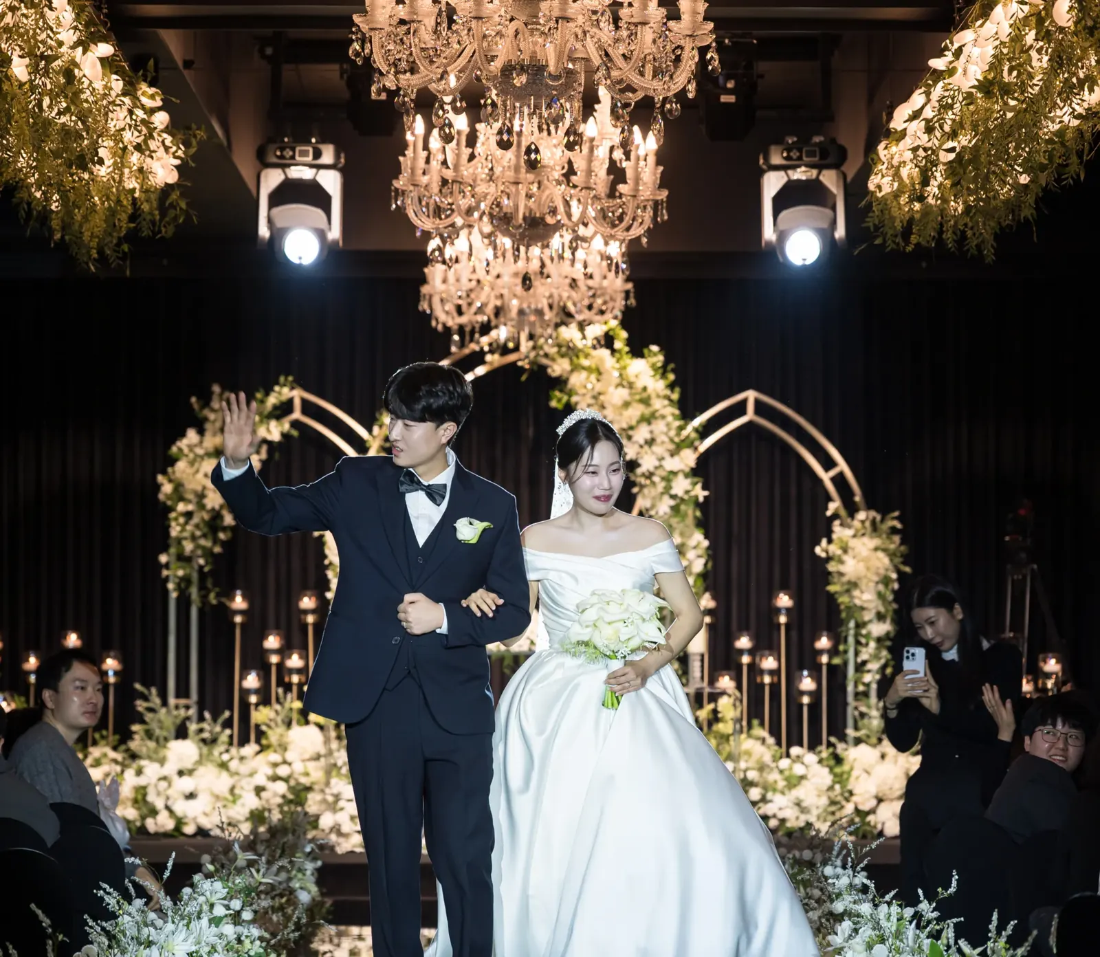 세인트메리엘 결혼식 하이라이트 영상 장면 — 행진하며 하객에게 손을 흔드는 신랑신부 (2025.01)